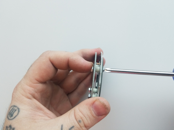 Side view of the stack as it is held and the nuts are tightened onto the backside of the assembly.