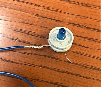 Blue 22 gauge wire soldered to a blue LED