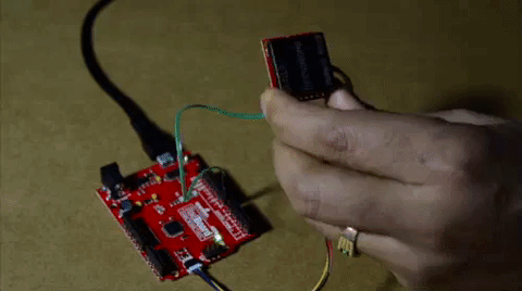 There is a gif here showing a person placing their RFID tag in range of the RFID module.