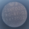Microscope detail of a part number including 25VF032B