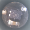 Microscope detail of an SMD part marked 3M3