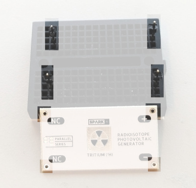 Four separate pin headers protrude from a small black breadboard.