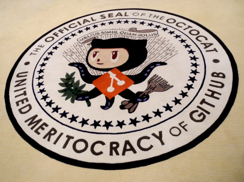 GitHub's former rug. The flawed "United Meritocracy of GitHub" has been supplanted by "In collaboration we trust"