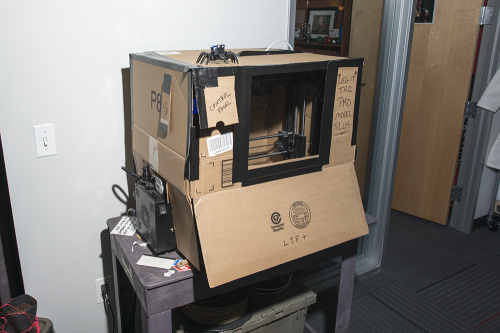 photo of a cardboard 3D printer enclosure held together with duct tape