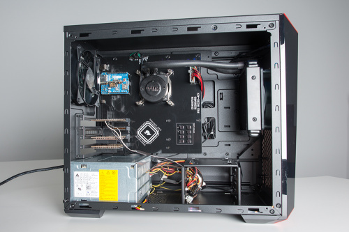 well lit photo of the same PC tower with the side panel removed so as to show the cooling loop in greater detail