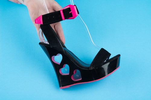 Fitting laser cut prototypes to heart cutouts in black wedge heels