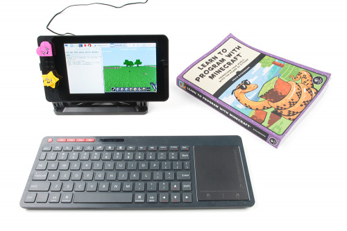 image of minecraft book and screen and keyboard next to it