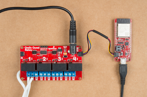 This image shows a picture of SparkFun's ESP32 thing Plus and Quad Relay connected together with a Qwiic connector, each being powered through a wall wart.