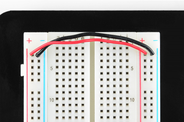 Jumper wires connecting both sides of the power rails