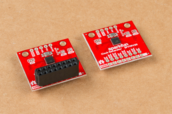 This image shows two Clock Generators side by side. On the left one, female headers have been soldered to the double row of PTH headers - the clock outputs.