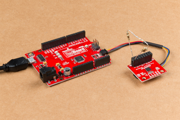 This image shows the SparkFun Clock Generator plugged into the Redboard Qwiic using a Qwiic cable.