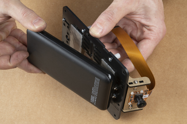 Demonstrating how to place the battery pack without touching the camera mount