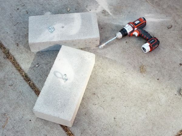 Ballast concrete blocks with broken eye-bolt