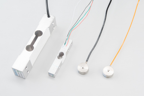 Four types of strain gauge load cells, two bar load cell and two disc load cells