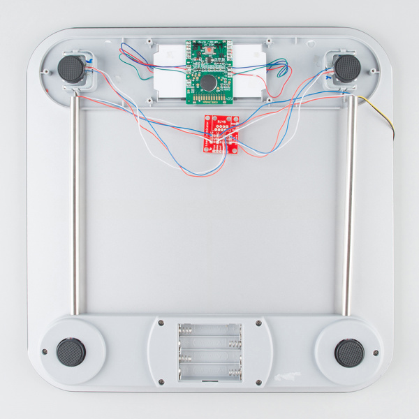 SparkFun's strain gauge load cell combinator board hooked up to a home scale, possible configuration for four disc load cells