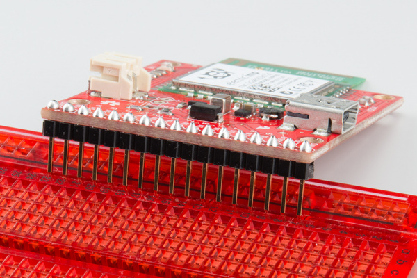 Headers soldered on to impt002 breakout, inserting into breadboard