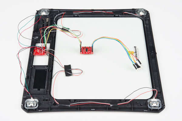 SparkFun's strain gauge load cell combinator board hooked up to a home scale, possible configuration for four disc load cells