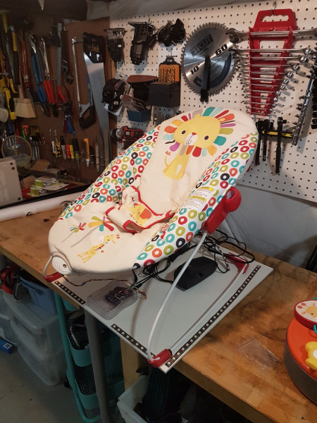 Bouncy chair mounted to baseboard