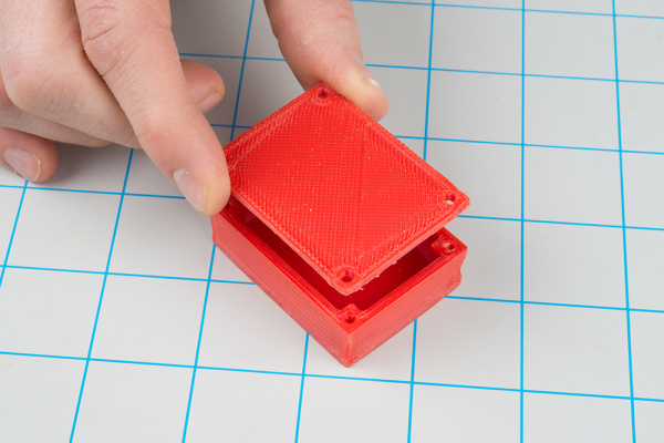 Lining up holes on the 3D printed lid with the rest of the box