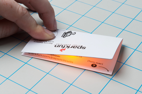 LED lighting up when folded template makes contact with the battery and completes the circuit