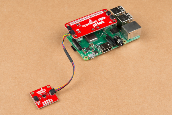 Qwiic pHat Inserted on Raspberry Pi and Connected to a Qwiic Sensor